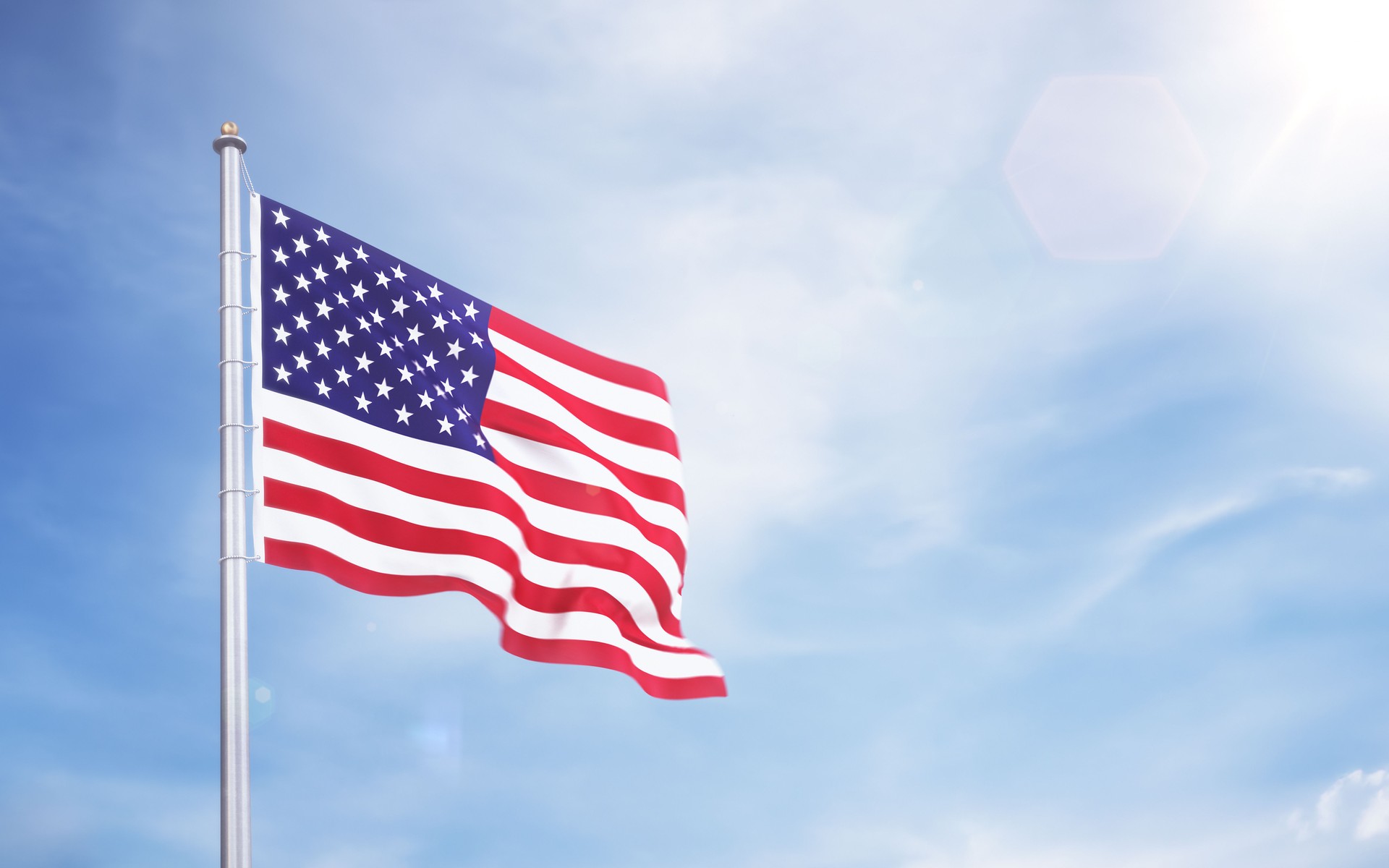 United States Flag Waving in the Wind in Blue Sky